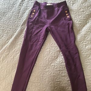 Girls, purple pants with gold button accent.